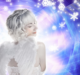 Beautiful Angel girl on abstract winter background