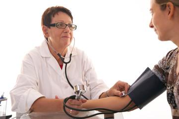 female doctor checking blood pressure with smile