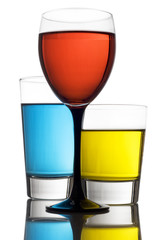 Glass of red wine with two colorful mixed drinks