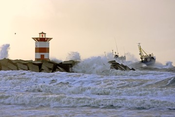 Fishingboat near lighthouse at a storm in Holland