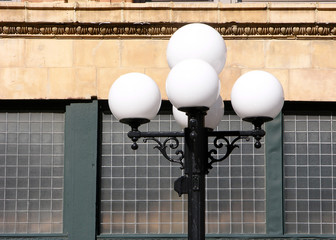 Vintage-style lamppost with grid windows in background
