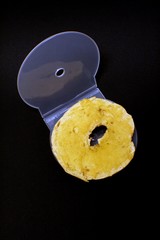 Toasted bagel with butter in a clear CD case