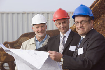 Engineers studying plans in harbor