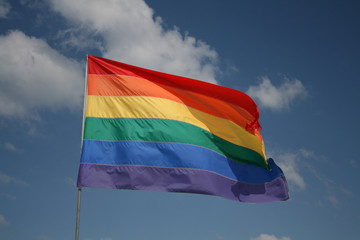 rainbow flag with blue sky