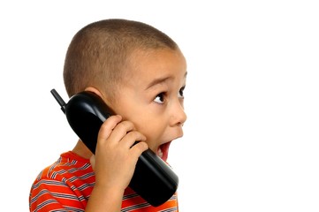 Boy surprised talking on telephone