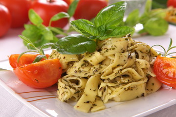 Spaghetti with pesto sauce and cheese