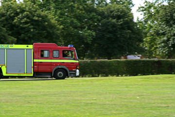 english fire engine attending an emergency call at speed