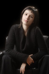 Naklejka premium Young woman against a dark background