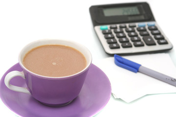 Cup from coffee and the calculator on a white background