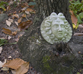 Face Sculpture against Tree