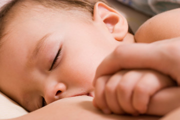 Little kid sleeping and breast-feed