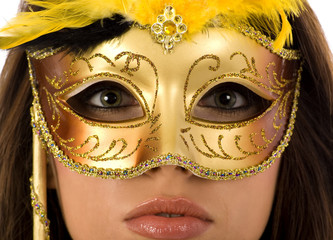  beautiful young woman wearing gold carnival mask