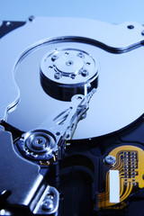 Close-up view of the opened hard disk drive(toned in blue mode)