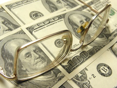 The eyeglasses lying on dollars