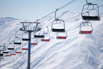 Ski lift chairs on bright winter day