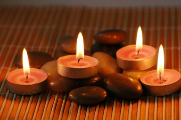 Obraz na płótnie Canvas Candles on the pebbles for aromatherapy session