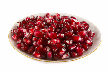 Saucer filled with pomegranate berries