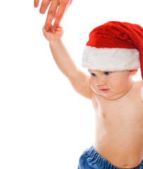 Adorable toddler in Christmas hat holding mother's hand