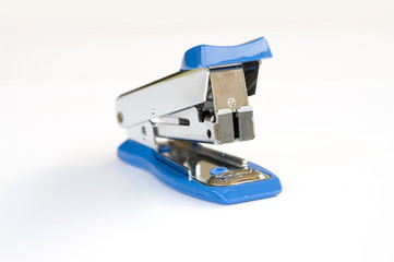 Blue stapler on white background 