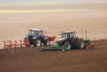 Two Tractors ploughing field in autumn