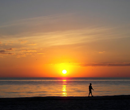 walking on the florida beach at sunset