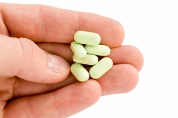 Man's hand with pills