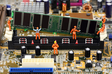 Miniature workers installing RAM memory