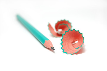 green pencil with cuttings in curve shape isolated on white