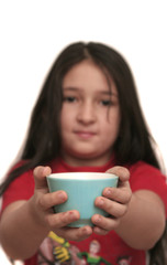 Cup with milk in hands of the girl