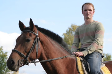Obraz premium Emotions young men which goes on a horse 