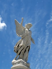 winged angel statue against blue sky