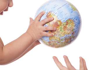 Globe in baby's  hands.