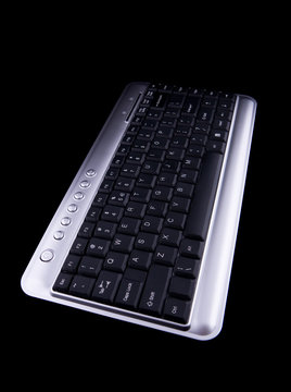Computer keyboard on black background