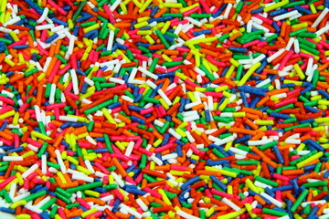 Fototapeta na wymiar fine multi colored candy sprinkles as background