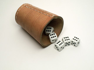Leather dice-box and dice and on white background