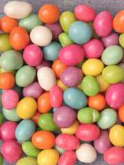 Fototapeta na wymiar Many multi-coloured sweets lay on a table
