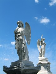 Fototapeta premium Detail of winged angel statue against blue sky