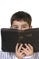 Boy Peering Over Bible