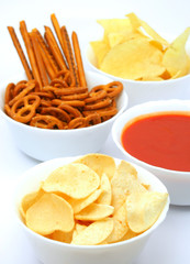 Potato chips and other snacks with hot salsa dip