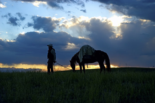 Cowboy with pack horse at dawn