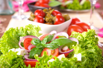 Fresh salad with onion, tomato and basil