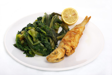 fried fish and vegetables in white dish