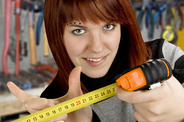 Redhead girl with measuring tool ruler