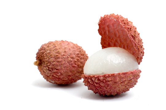 2 lychees, one is cut in half and opened