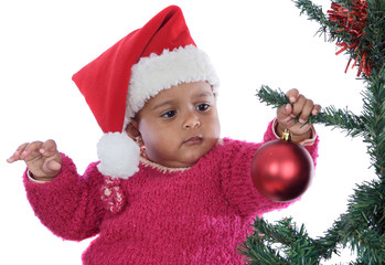 baby girl playing with christmas tree