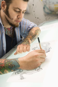 Man drawing tattoo.