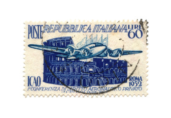 Postage stamp from Italy dated 1952 with airplane and colosseum