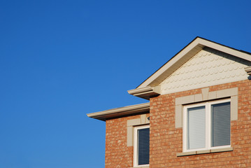 Fototapeta na wymiar Section of a new house against blue sky