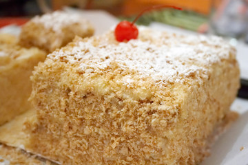 Sliced biscuit cake with cherry berry at the top 1