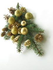 Fototapeta na wymiar green coniferous twig with golden tinsels